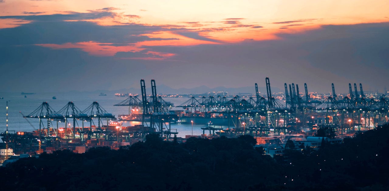 Scenery of a large harbour with many cranes, sunset